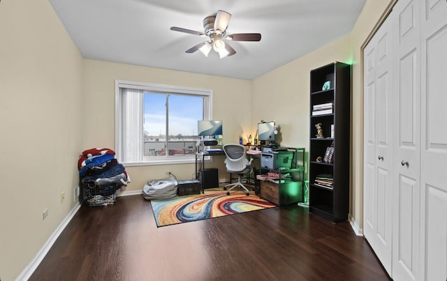 home office featuring a ceiling fan, baseboards, and wood finished floors