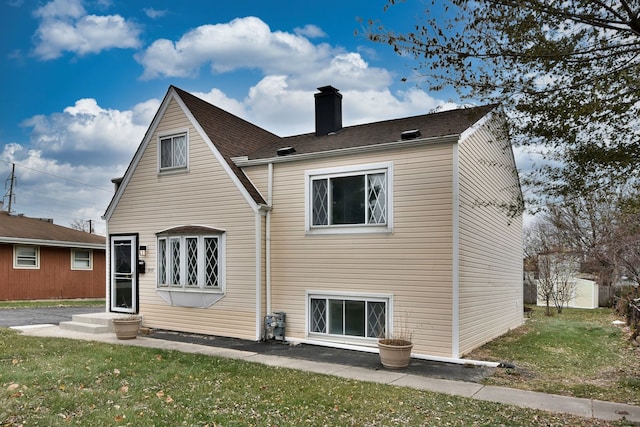 rear view of property with a lawn