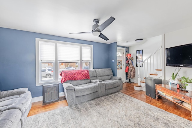 living room with ceiling fan and light wood-type flooring