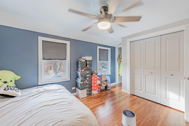 bedroom featuring hardwood / wood-style flooring, ceiling fan, and a closet