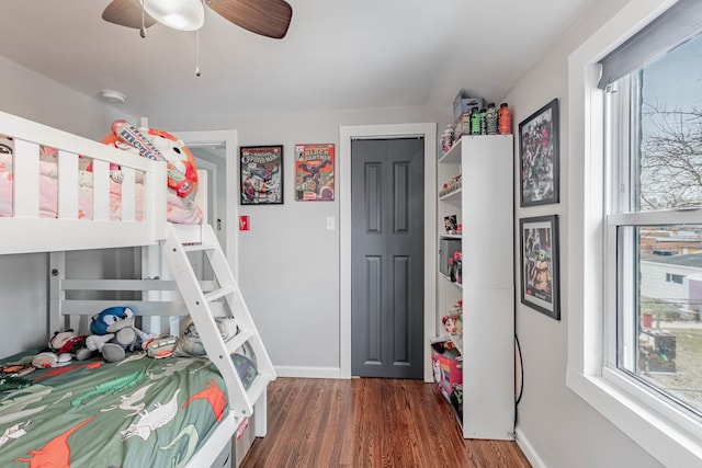 bedroom with dark hardwood / wood-style floors and ceiling fan