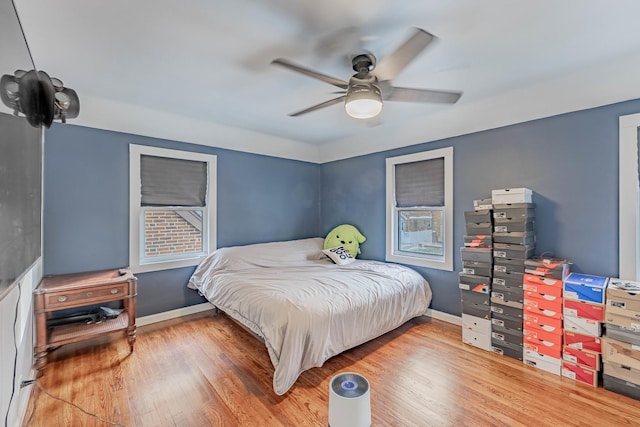 bedroom with hardwood / wood-style flooring and ceiling fan