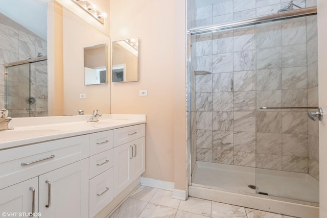 bathroom with marble finish floor, a sink, and a shower stall