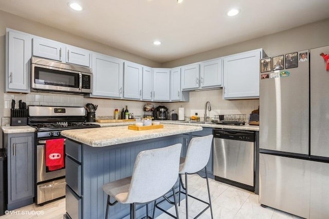 kitchen featuring appliances with stainless steel finishes, a center island, and white cabinets