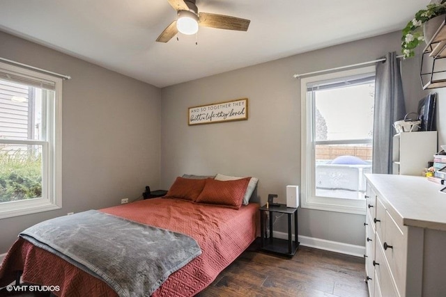 bedroom with multiple windows, dark hardwood / wood-style floors, and ceiling fan