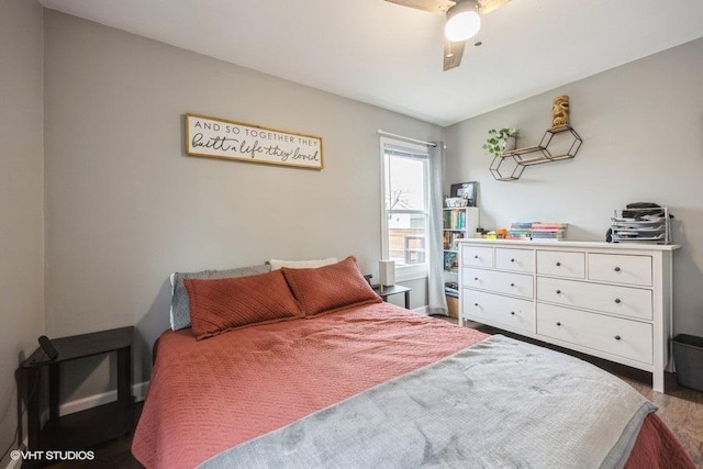 bedroom with dark hardwood / wood-style flooring and ceiling fan