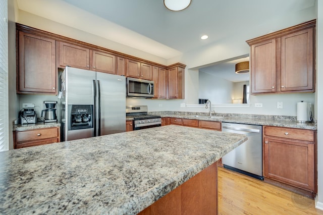 3460 Bradbury Cir, Aurora, IL 60504 - kitchen with appliances with stainless steel finishes, a sink, light wood-style flooring, recessed lighting, and brown cabinetry
