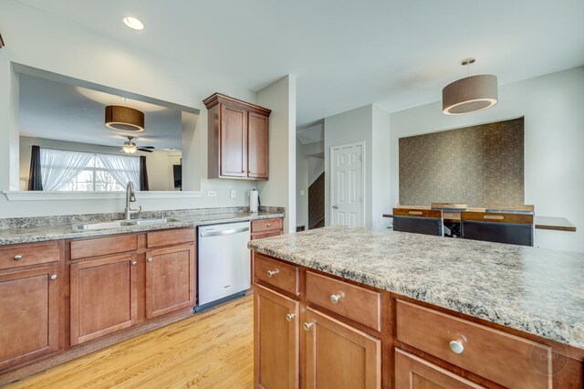 3460 Bradbury Cir, Aurora, IL 60504 - kitchen with dishwasher, a sink, light wood-style flooring, light countertops, and brown cabinetry