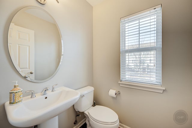 3460 Bradbury Cir, Aurora, IL 60504 - half bath featuring baseboards, healthy amount of natural light, a sink, and toilet