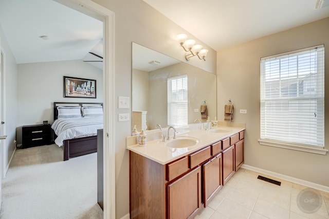3460 Bradbury Cir, Aurora, IL 60504 - full bathroom with baseboards, double vanity, vaulted ceiling, ensuite bath, and tile patterned flooring