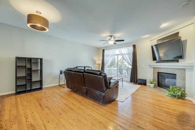 3460 Bradbury Cir, Aurora, IL 60504 - living area with ceiling fan, light wood-type flooring, a tile fireplace, and baseboards