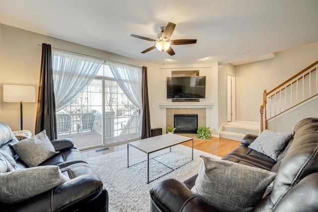 3460 Bradbury Cir, Aurora, IL 60504 - living area with a ceiling fan, stairway, wood finished floors, and a tiled fireplace