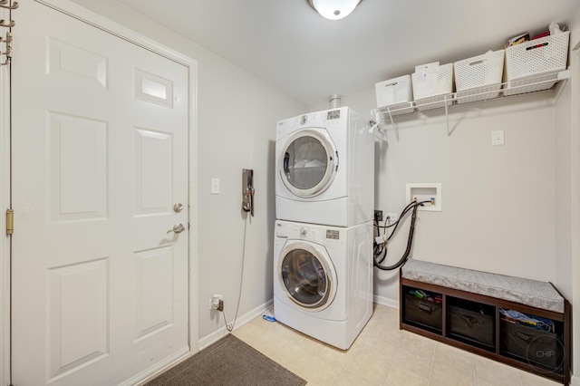 3460 Bradbury Cir, Aurora, IL 60504 - laundry area with stacked washing machine and dryer, baseboards, and light tile patterned floors