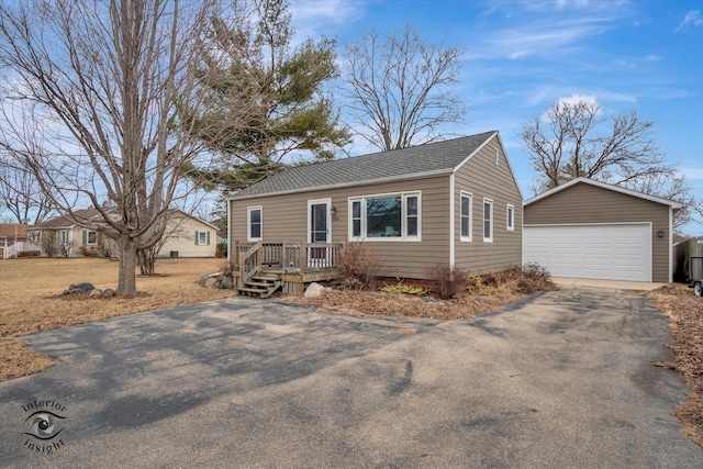 view of front of house with a garage and an outdoor structure