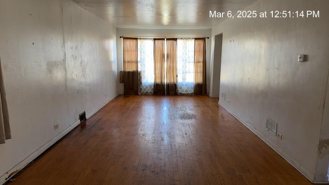 spare room with visible vents and wood finished floors