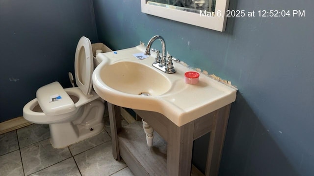 half bath with tile patterned floors and toilet