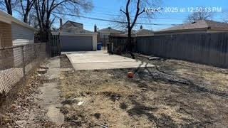 view of yard featuring an outbuilding, a patio, and a fenced backyard