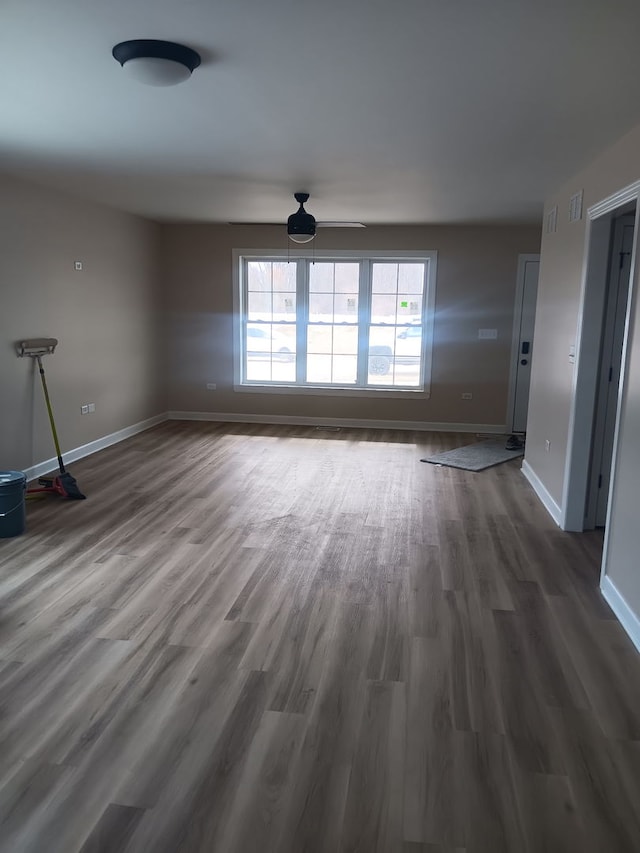 unfurnished living room with ceiling fan and hardwood / wood-style floors