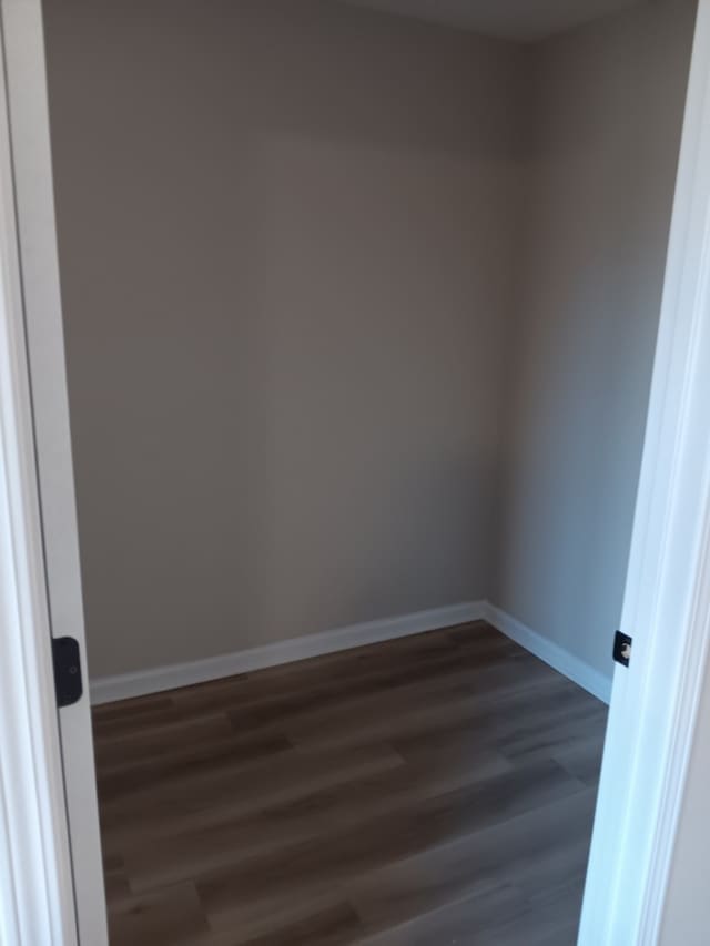 spare room with dark hardwood / wood-style floors