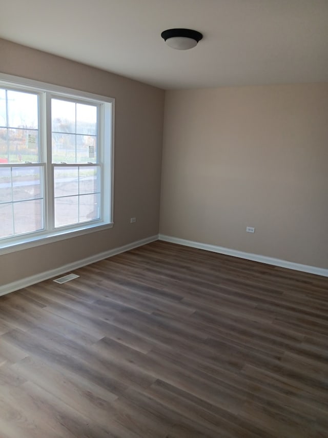 unfurnished room featuring dark wood-type flooring