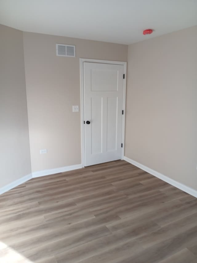 unfurnished room featuring wood-type flooring