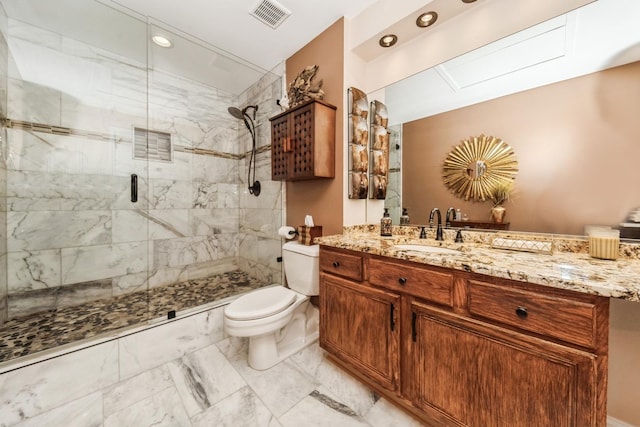 bathroom featuring vanity, walk in shower, and toilet