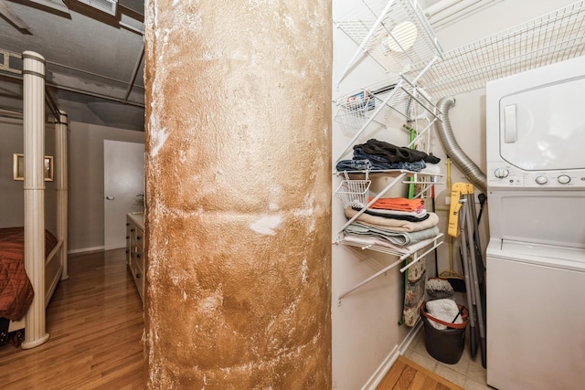 interior space featuring stacked washing maching and dryer and hardwood / wood-style floors