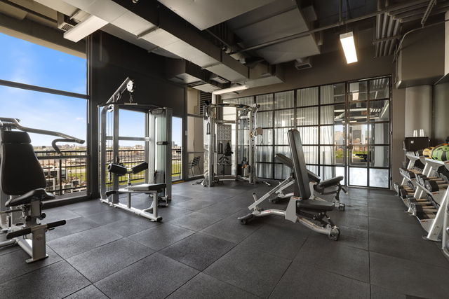 exercise room with floor to ceiling windows