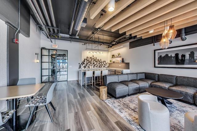 living room featuring hardwood / wood-style flooring and indoor bar