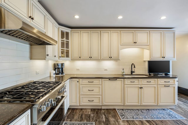 kitchen with stainless steel range with gas cooktop, sink, dark wood-type flooring, and cream cabinets