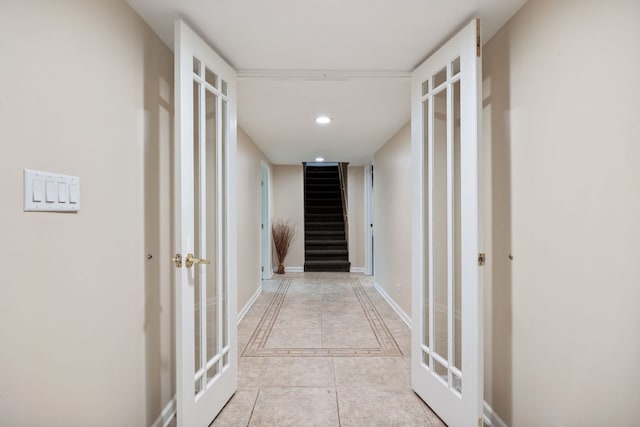 hall featuring french doors and light tile patterned flooring