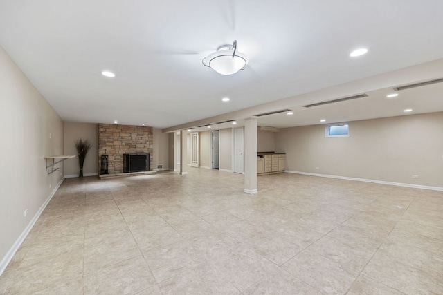 basement featuring a stone fireplace