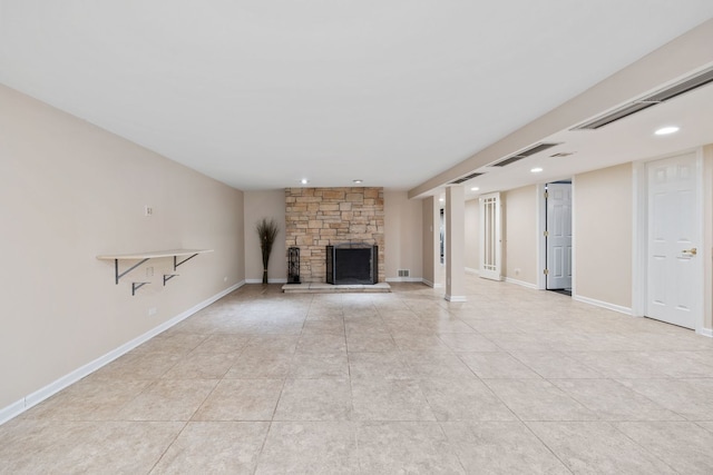 unfurnished living room with light tile patterned flooring and a stone fireplace