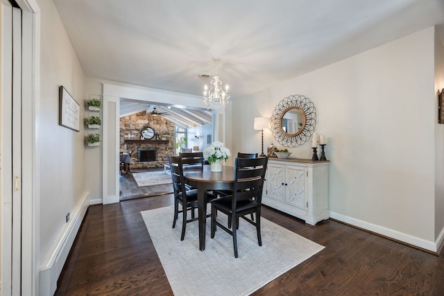 dining room with a stone fireplace, dark wood-type flooring, lofted ceiling with beams, and ceiling fan with notable chandelier