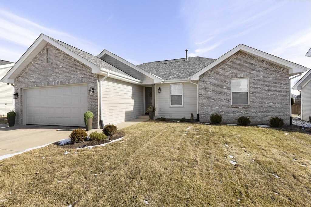 ranch-style home featuring a garage and a front yard