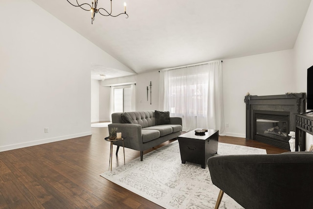 living room with lofted ceiling, dark hardwood / wood-style flooring, and a notable chandelier