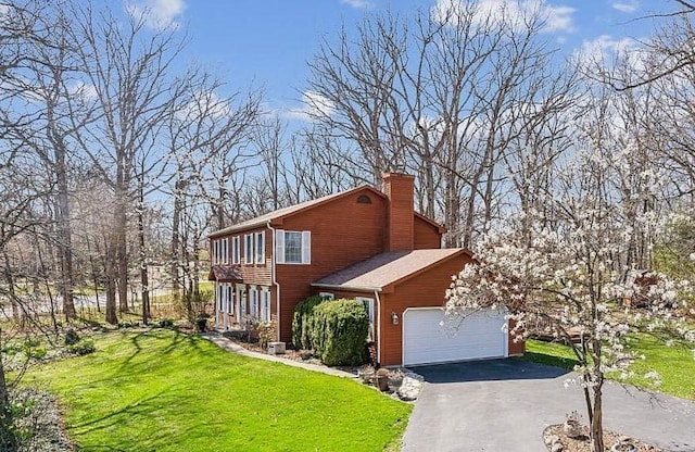 front facade featuring a garage and a front lawn