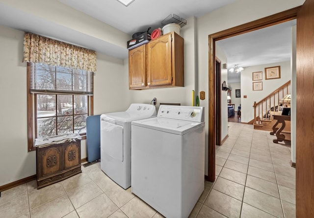 laundry room featuring cabinets, washer and dryer, and light tile patterned flooring