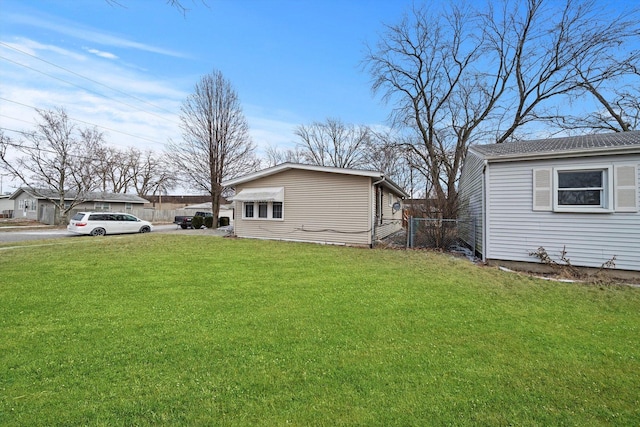 view of side of property with a lawn