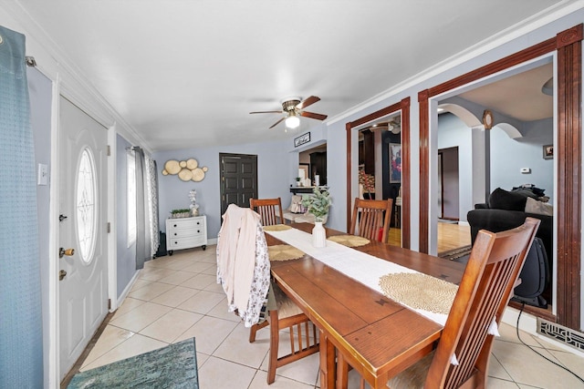 tiled dining area with crown molding and ceiling fan