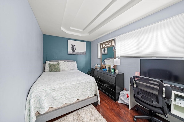 bedroom with dark hardwood / wood-style flooring