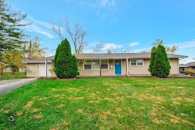 single story home with a garage and a front lawn