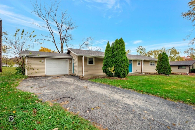 ranch-style house with a garage and a front lawn