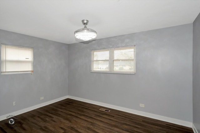 empty room with dark wood-type flooring