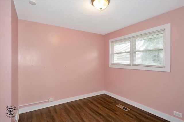 empty room featuring dark hardwood / wood-style flooring