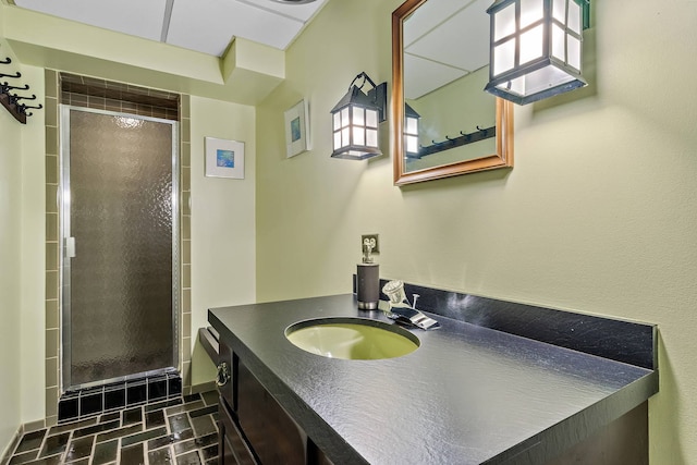 bathroom with vanity and a shower with shower door