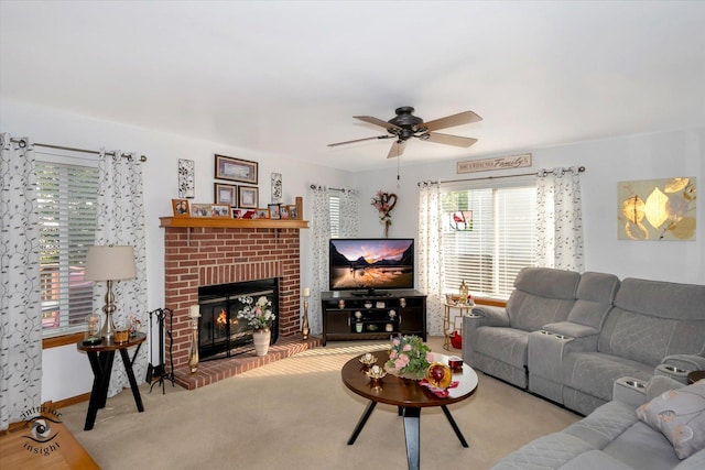 carpeted living room featuring ceiling fan and a brick fireplace