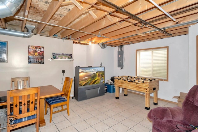 rec room with tile patterned flooring and electric panel