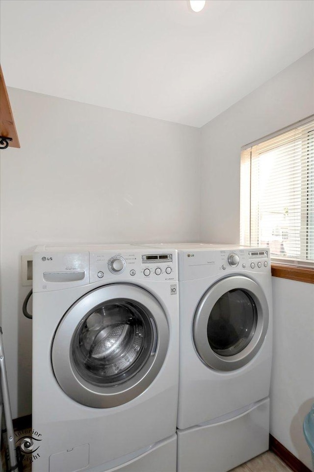 clothes washing area with independent washer and dryer