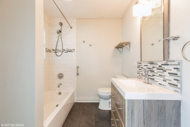 full bathroom with tiled shower / bath, tasteful backsplash, vanity, toilet, and tile patterned floors